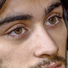 a close up of a man with brown eyes