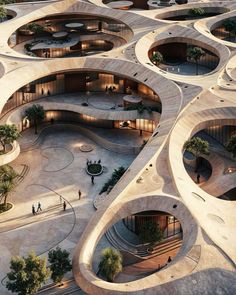 an aerial view of a building with many circular spaces and trees in the center, as well as people walking around