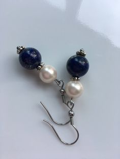 "A 10mm Lapis lazuli gemstone with 8mm ivory shell pearls, this earrings about 2\" long top to bottom, and it's made with stainless steel Hypoallergenic. Hand made jewelry." Elegant Blue Pearl Earrings With Natural Stones, Nickel-free Blue Pearl Earrings Gift, Blue Sterling Silver Pearl Earrings As Gift, Blue Pearl Dangle Earrings, Handmade Blue Pearl Earrings, Round Pearl Earrings, Pearls Earrings, Lapis Lazuli Gemstone, Beads Earrings