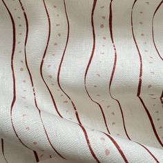 a white and red fabric with wavy lines