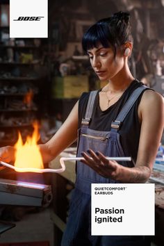 a woman is working on a piece of metal with flames in the background and text that reads, passion ignted