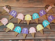 an ice cream cone birthday banner on a wooden table