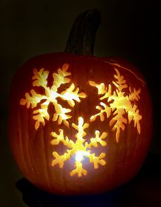 a carved pumpkin with snowflakes on it