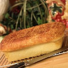 a loaf of bread sitting on top of a table next to a knife and fork