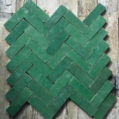 the green tile is laid out on top of wooden planks, which have been used as a wall decoration