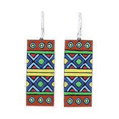 pair of earrings with colorful geometric design on the front and back ends, hanging from silver hooks