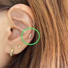 a close up of a person's ear with a green circle around it