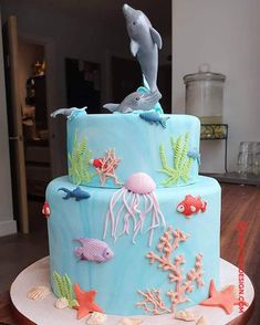 a blue cake decorated with sea animals and corals