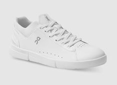 a white tennis shoe on a grey background