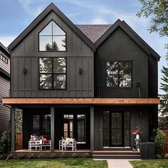 a large gray house with lots of windows