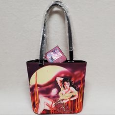 Vintage Deadstock Forelle Cinema Collection Popart Multi-Color Handbag Purse. This Is An Amazing Vintage Deadstock, New With Tag, Purse By Forelle Of A Beautiful Gun Slinging Actress. Brightly Colored With A Gorgeous Actress Toting And Revolver, Wearing A Super Low Cut Dress Covered In Sequins And Surrounded By Fire. Same Photo On Back Without Sequins. Medium Size Bag With Double Shoulder Handles And Silver Hardware. Inner Lining Of White And Red Stars, Light Yellowing From Age, With A Large Poc Retro Red Bags With Handles, Retro Red Bag With Top Carry Handle, Retro Bucket Bag With Large Capacity, Retro Rectangular Bag With Zipper Closure, Retro Bags With Zipper Closure For Gift, Retro Bag With Zipper Closure As Gift, Retro Gift Bag With Zipper Closure, Retro Red Bag With Zipper Closure, Retro Red Bag With Removable Pouch