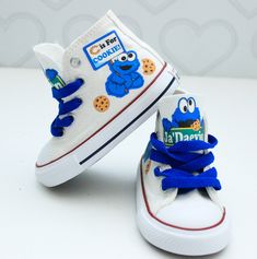 two children's shoes with cookie cookies painted on the bottom and one has blue laces