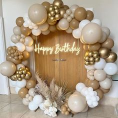 a happy birthday balloon arch with gold and white balloons