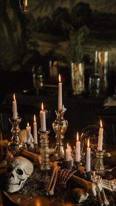 a table topped with lots of candles and skulls