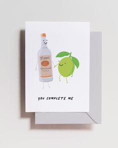 a greeting card with an image of a bottle of gin next to a lime and the words, you complete me