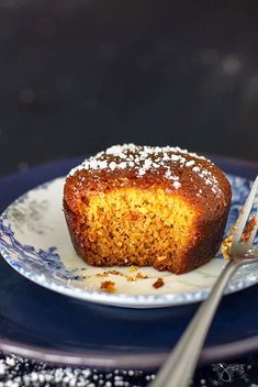 a piece of cake sitting on top of a blue and white plate next to a fork