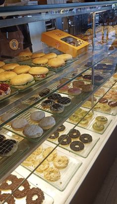 a display case filled with lots of different types of donuts and other pastries