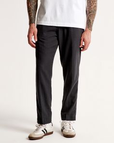 Our permacrease trouser in a linen-blend fabric and loose fit through the leg, featuring a fixed waistband and button fly closure. Features a shorter inseam designed to hit at the ankle and give a cleaner visual. For a standard visual, choose a longer inseam. Men's Bottoms, Black Texture, Black Textures, Mens Trousers, Mens Bottom, Abercrombie Fitch, Linen Blend, Zip Pockets, Loose Fitting