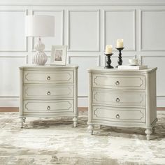 two white dressers sitting next to each other on top of a carpeted floor