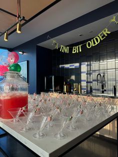 there are many wine glasses lined up on the table in front of an advertisement for tinni bit order