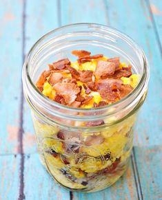 a glass jar filled with food sitting on top of a blue table