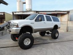 a large white truck parked in front of a building