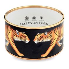 This enamel cuff makes a roaringly stylish statement piece. It has been handcrafted and two majestic, stalking tigers have been hand-painted by our artisans.  The piece features the Halcyon Days hallmark on the inner rim and raised 18ct gold plated edges. Gold Tiger, Black Bangle, Halcyon Days, Yellow Gold Bangle, Painted Jewelry, Enamel Bangle, Candles For Sale, Gold Bangle, Hinged Bangle