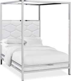 a white bed with a metal frame and headboard