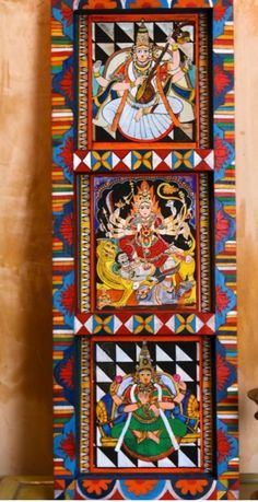 an intricately painted wooden door with four images on it