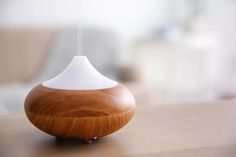 a wooden diffuser sitting on top of a table