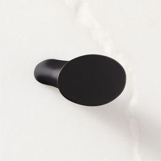 a round black object on a white surface