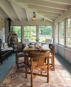 a dining room table with chairs and a birdcage