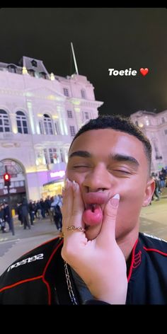 a man with his tongue hanging out in front of a building