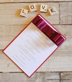 the word love spelled with scrabbles on top of a card