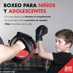 a young boy is getting ready to hit a boxing glove on his father's arm