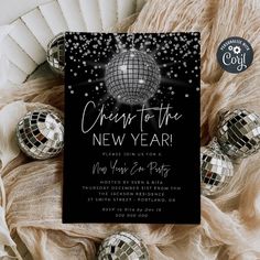 a black and white new year's eve party card with disco balls on it