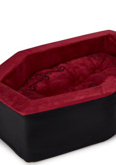 a red and black dog bed on a white background with the cover pulled back to reveal it's inner corner