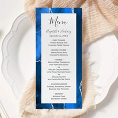 a blue and white menu card sitting on top of a plate