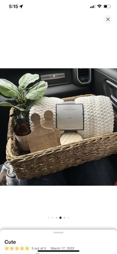 a basket filled with items sitting on top of a car seat next to a plant