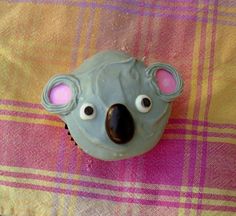 a cupcake shaped like a koala with eyes