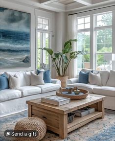 a living room filled with furniture and a painting hanging on the wall above a coffee table