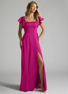 a woman in a long pink dress posing for the camera with her hands on her hips