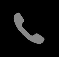 a black and white photo of an old phone on a dark background with the letter c