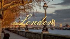 the words london are lit up by street lamps