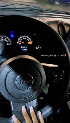 a woman driving a car with her hands on the steering wheel and dashboard gauges