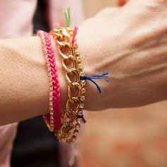 a woman's arm with three bracelets on it