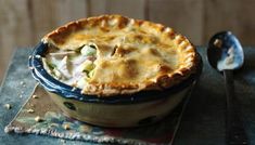 a close up of a pie in a bowl on a table with a cloth underneath it