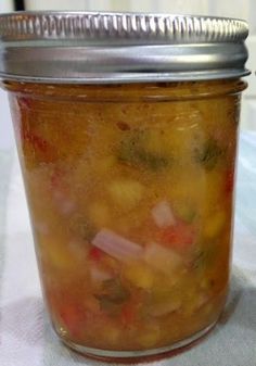 a jar filled with soup sitting on top of a table