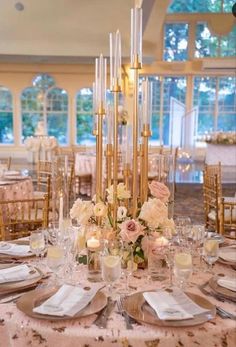 an elegant table setting with candles and flowers