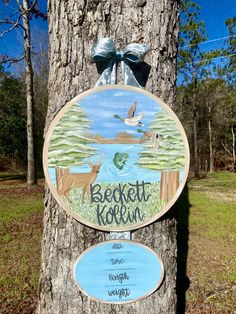 a sign on the side of a tree that says beckton korem and two deer